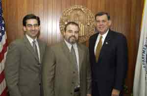 Xavier Cortada with Secreraty Martinez, right, and Chief of Staff Frank Jimenez inside the Secretary's Office.